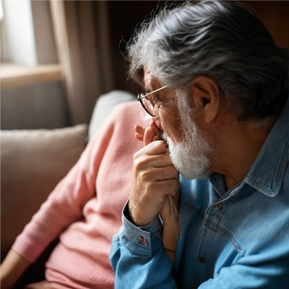 Older man holding his wife's hand