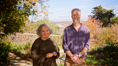 Danni Moore and Kynan Sutherland standing in front of a garden