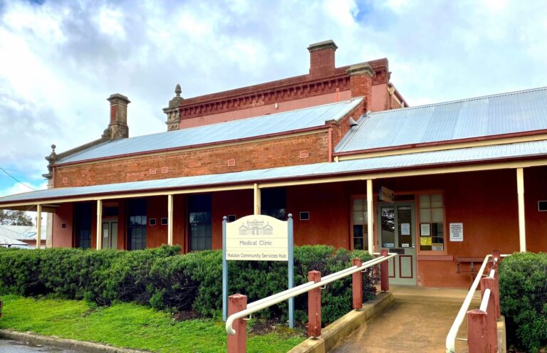 red brick building with ramp to front door and sign out front for Maldon Medical Clinic